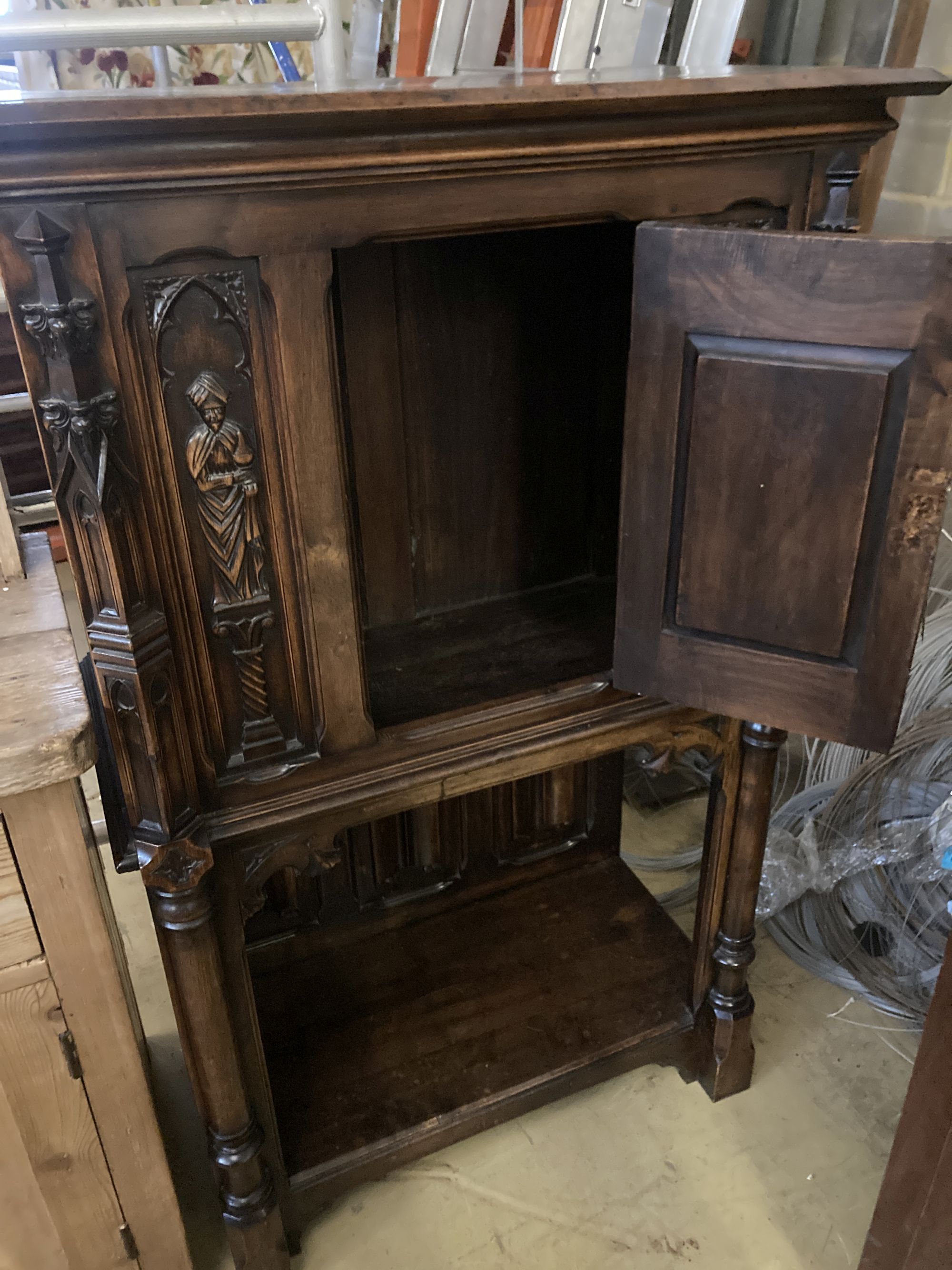 A medieval style carved walnut side cabinet, width 90cm, depth 44cm, height 140cm